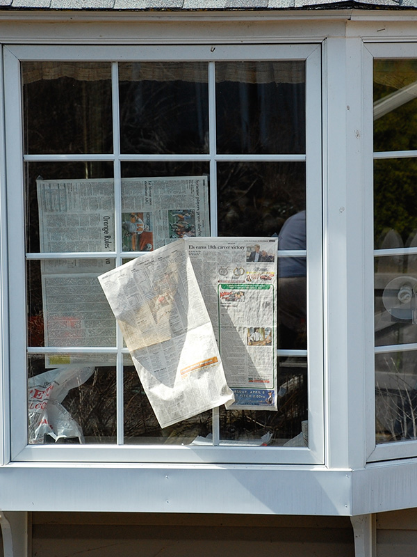 Window covered with newspaper