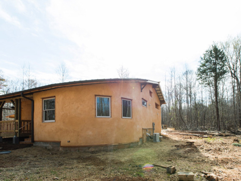 Back of Creekside with the curved wall of the office