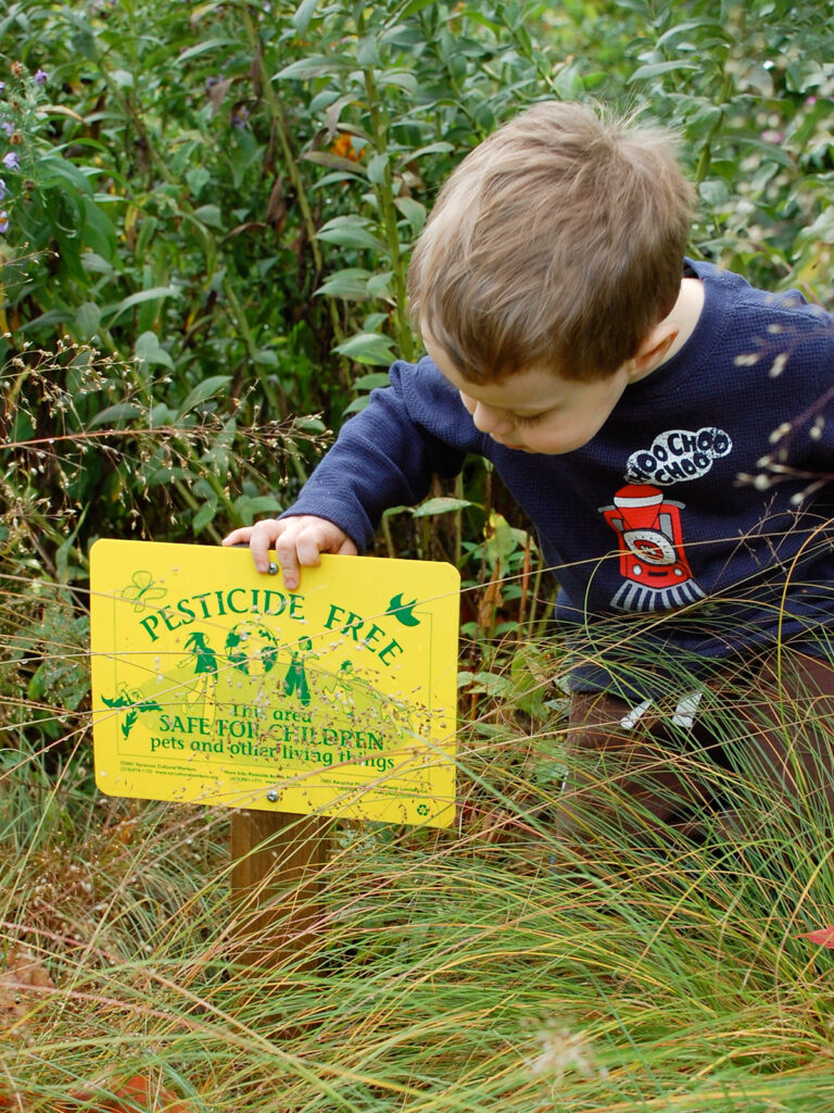 Child looking at pesticide sign