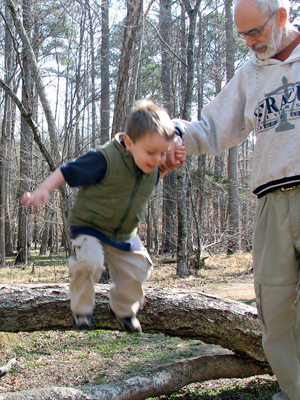 Child jumping from a log